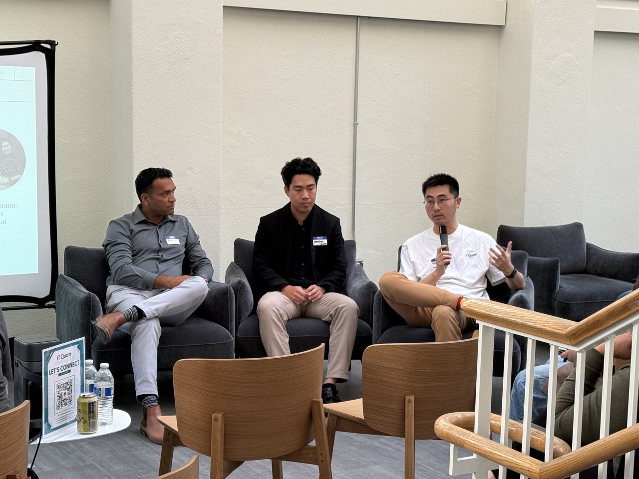 Quotr.ai Co-Founder (Hanyang Liu) speaking into microphone during fireside chat