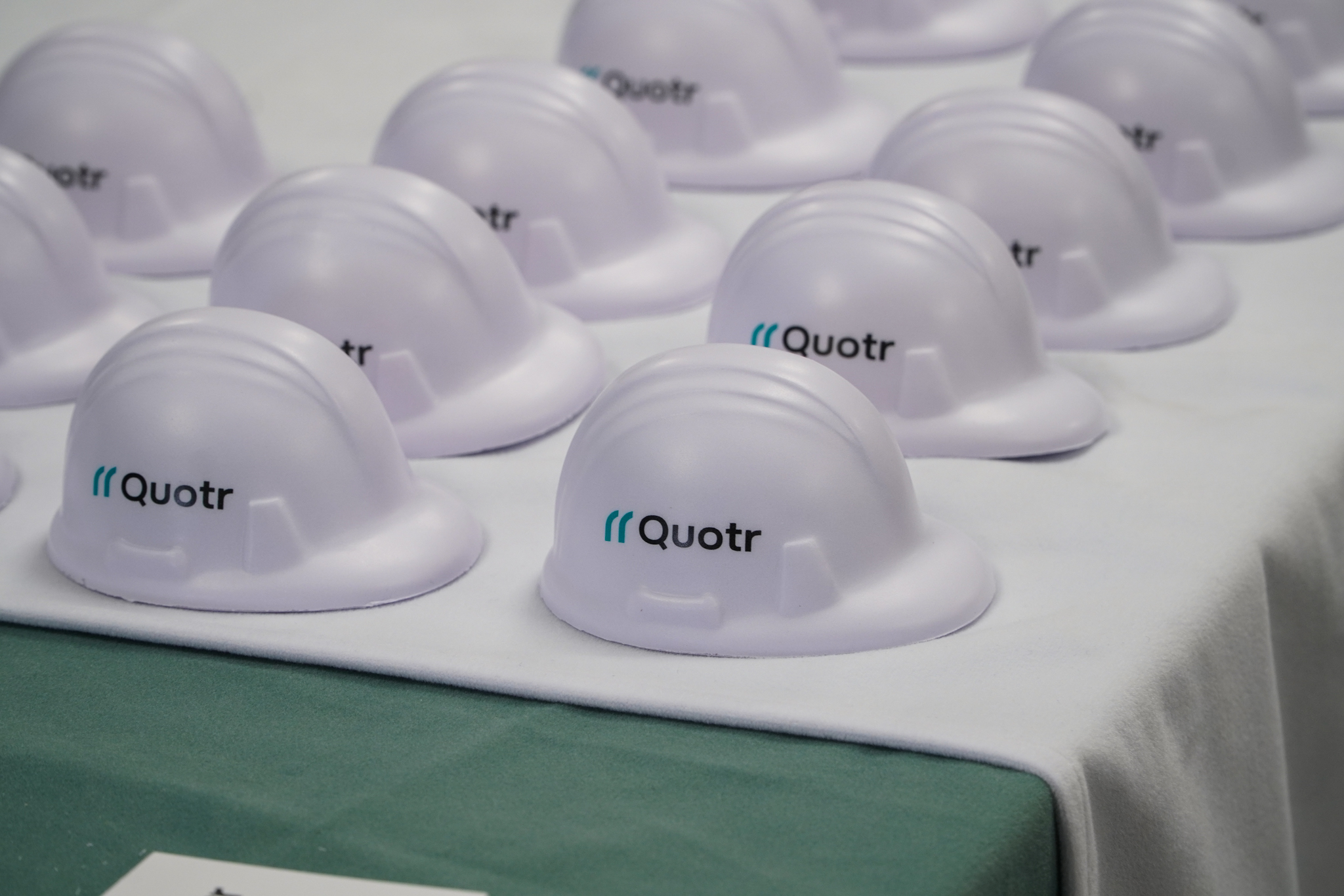 Quotr.ai construction helmet merchandise display.